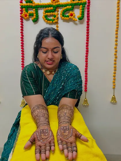 A happy client showcasing her engagement mehndi. We love being a part of our clients' special moments.