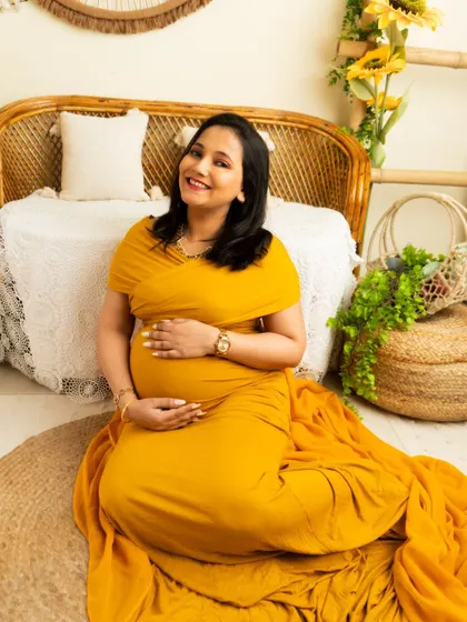 A classic seated portrait in a beautiful yellow gown. The soft lighting and relaxed pose create a warm and inviting image.