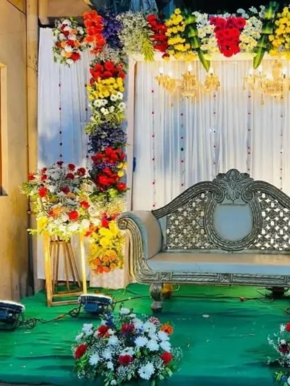 A close-up shot of the colorful engagement stage, highlighting the intricate floral work and chandelier details.