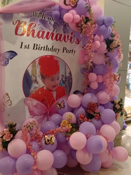 A beautiful butterfly theme for Bhanavi's first birthday. The welcome sign is draped with soft tulle and surrounded by pink and purple balloons.