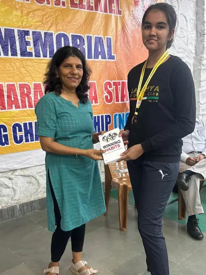 Varsha Nikharge being presented with her award after winning a silver medal in the 10m Air Pistol event.