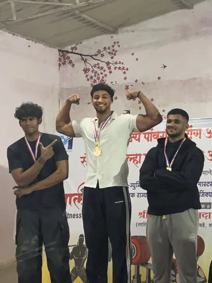 An athlete celebrating his gold medal at the Maharashtra State Championship. A dominant performance with a 605kg total in the 83kg junior category.