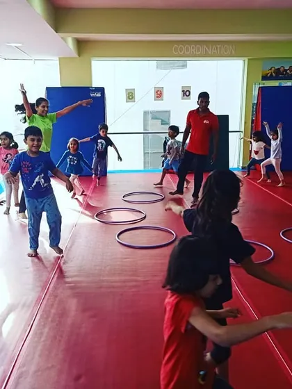 Our "Giggle Worms" enjoying a warm-up activity with hula hoops, learning about numbers and counting while they move.