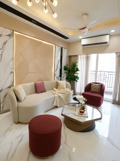 Welcome to our ACE Divino project. This living room balances modern elegance with everyday comfort, using a mix of geometric wall panels, a curved sofa, and pops of deep red for a warm, inviting feel.
