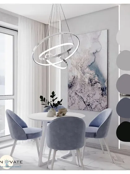 This dining area showcases a cool, elegant color palette of purple-grey. The modern ring chandelier and abstract wall art create a sophisticated ambiance perfect for a contemporary home.