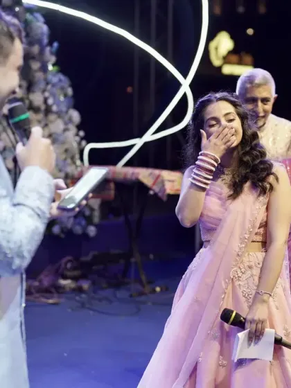 The groom delivers a heartfelt speech for his bride, bringing a smile to her face during their engagement ceremony.