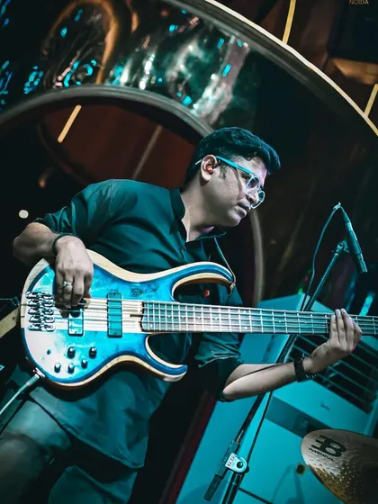 Our talented bassist laying down the groove. His steady and melodic bass lines are the foundation of our fusion sound.