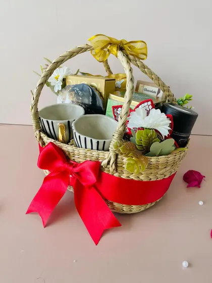 A side view of the oval Kauna basket, showcasing the hand-woven texture and the abundance of gifts packed inside.