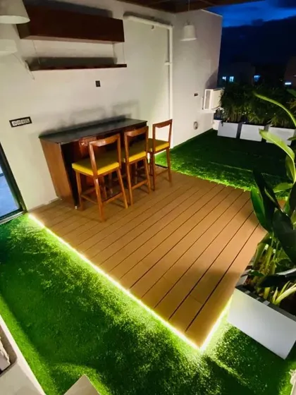 The terrace at night, where integrated LED strip lighting along the wooden deck creates a warm and inviting ambiance. This highlights how thoughtful lighting design can completely change the mood of an outdoor space.