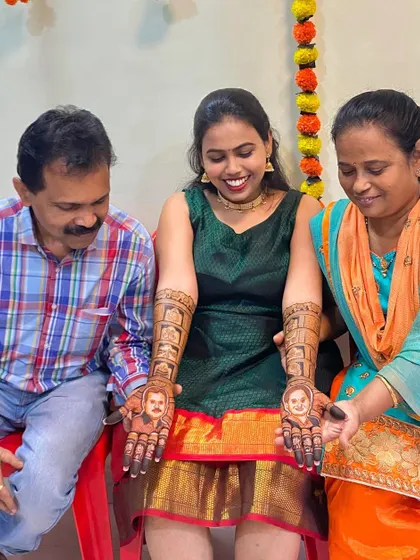 The bride's parents admiring the henna portraits of themselves on their daughter's hands. These moments are what make personalized mehendi so special.