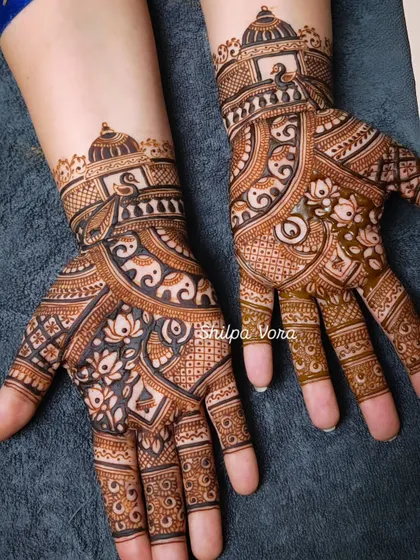 A detailed design featuring elephants, lotuses, and a small dome motif, perfect for a bride who loves traditional symbols.