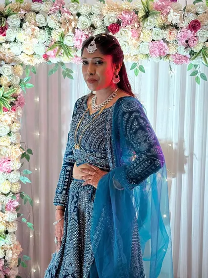 A client looking gorgeous in a blue velvet lehenga with silver embroidery. This is a great option for a reception or cocktail party.