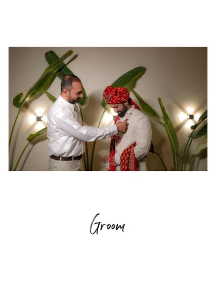 A heartwarming moment of the groom getting ready, with his father or a close relative helping him with his attire.