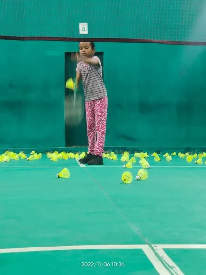 A young girl practices her swing during a drill, showing the determination we nurture in our players.