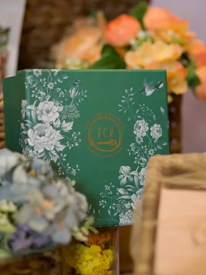 A close-up of our Pradan 2.0 box hamper. This festive green box is perfect for corporate gifting, offering a delightful mix of our eggless and refined flour-free treats.