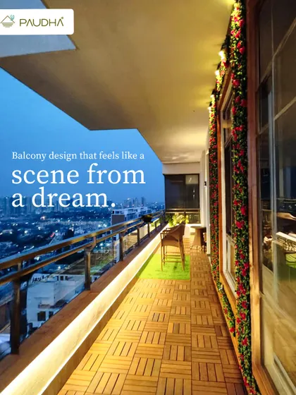 A balcony design that feels like a scene from a dream. The wooden deck flooring, festive garlands, and the stunning city view at dusk create a magical and serene atmosphere.
