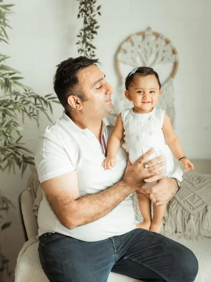 A father's loving gaze at his smiling daughter. These father-daughter moments are so special.