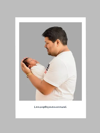 A classic polaroid-style portrait of a father tenderly holding his newborn, showcasing the strength and gentleness of a new dad in a simple, clean composition.