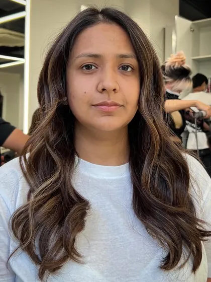 A happy client with her new balayage. The goal is always to create hair that not only looks great but also makes you feel great.