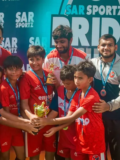 This U-9 team celebrates with their coaches after winning the Pride Cup.