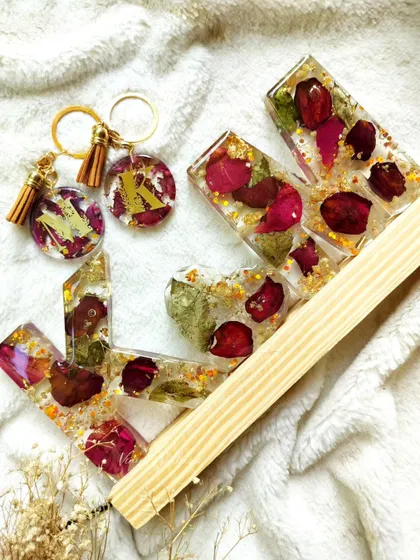 The full set of "KM" monogram letters and matching keychains, ready to be cherished.