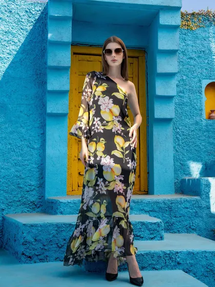 A full-length shot of a one-shoulder dress from the Tangerine Tiger campaign. The addition of sunglasses and a confident pose elevates this from a simple product shot to a complete fashion statement.