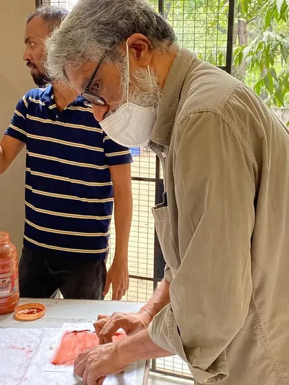 Guiding a student in the metal etching and printmaking process at a workshop. Sharing these traditional craft techniques is part of my commitment to fostering a deeper understanding of the connection between art and architecture.