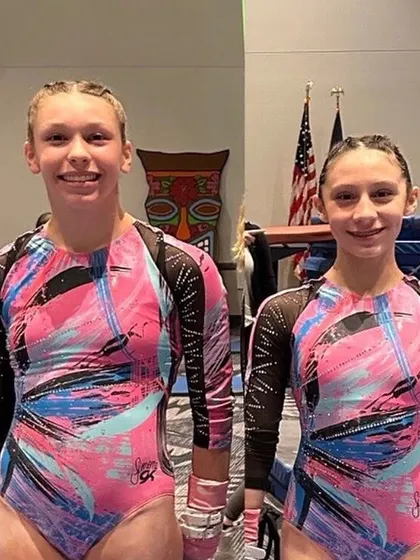 Two of our Xcel athletes at the Luau Invitational, ready to compete.