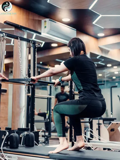 This squat variation on the Trapeze Tower works the glutes, quads, and calves. It's a challenging exercise that builds lower body strength and control.