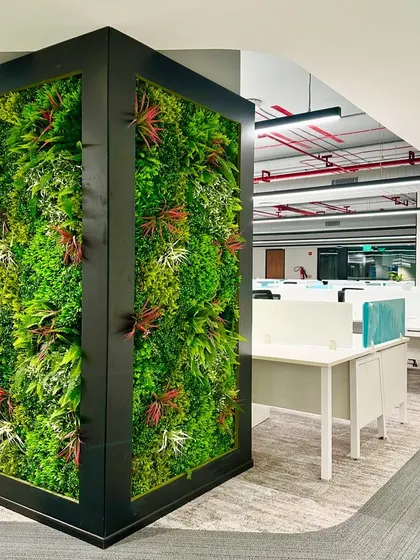 Another view of the green wall pillar, showing how it enlivens the open-plan office environment. It serves as a natural-looking divider and a focal point for the entire floor.
