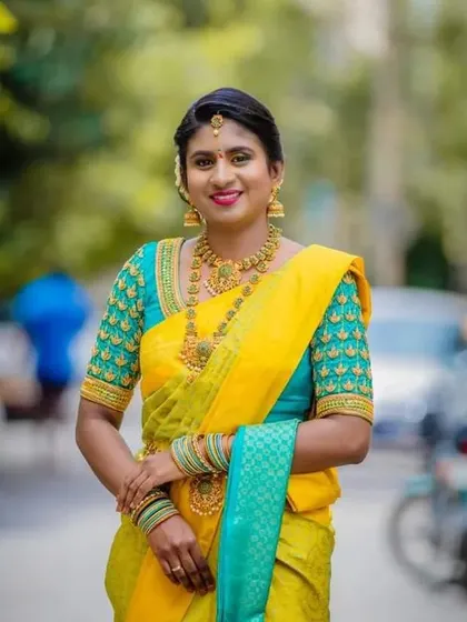 A vibrant and happy look for a special day. This client chose a bright yellow silk saree, and I designed a contrasting turquoise blouse with matching yellow and gold beadwork on the sleeves.