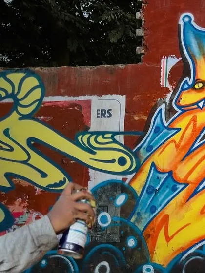 A behind-the-scenes shot of me adding details to the Graffiti Dragon. You can see the spray can in action, bringing the character to life.