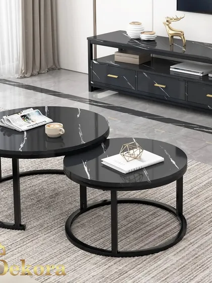 We designed this modern nesting coffee table set for flexible living spaces. Featuring two round tables with a black marble-finish top and minimalist black metal frames, they can be used together or separately to adapt to your needs.