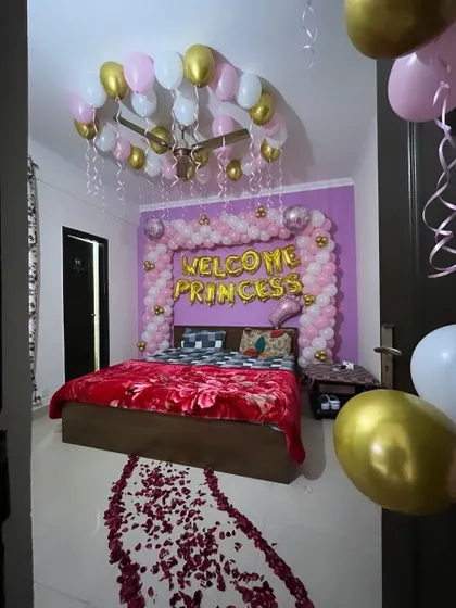 I can transform your bedroom into a beautiful sanctuary to welcome your little princess. This decoration includes a 'Welcome Princess' balloon arch over the bed, balloons on the ceiling, and a traditional rose petal pathway for that extra special touch.
