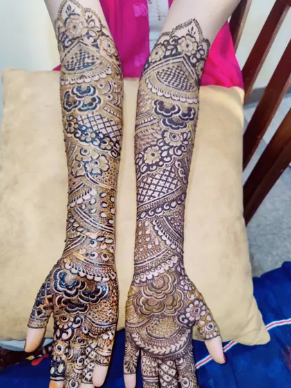 This image showcases a symmetrical design on both arms, featuring a mix of peacocks, florals, and geometric fills.
