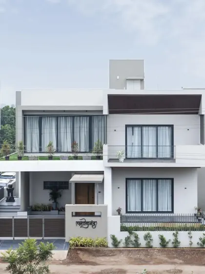 The home's modern exterior, captured with a passing horse-drawn cart, creates a poignant image of contemporary design in a traditional Indian context.