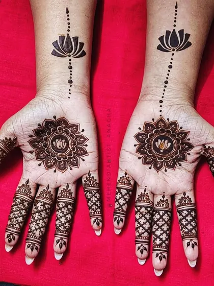 This striking design features a lotus mandala on the palm and a single lotus motif on the wrist, connected by a simple line. It's a perfect example of elegant minimalism.