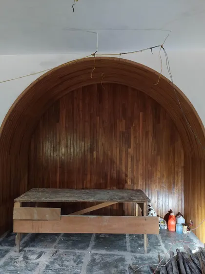 The completed wood-lined arch, creating a warm and intimate alcove that holds personal history within the larger space.