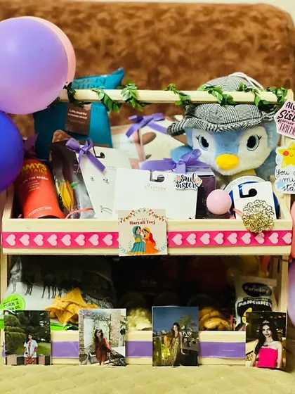 Another view of the two-tiered sister's Rakhi hamper, showcasing the personalized photos and fun stickers like "Always Sister, Forever Friend."