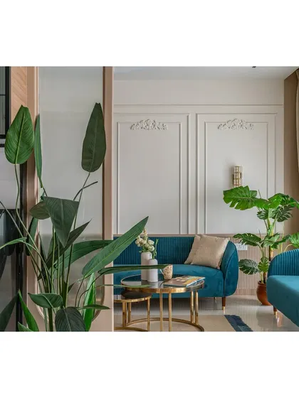 This shot captures the balance between the bold sofa and the neutral background, a key principle in our modern design approach. The plant adds a natural, organic element to the structured space.