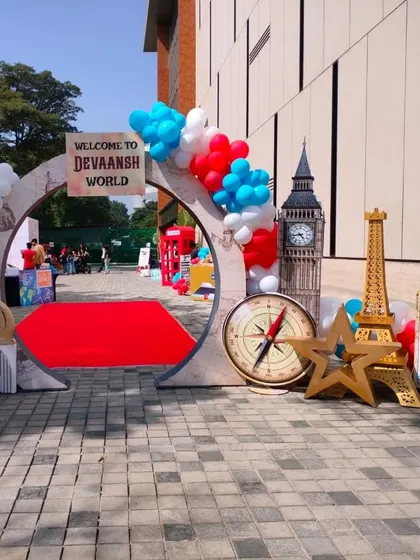 This "Around the World" themed entrance showcases custom-made props like Big Ben and the Eiffel Tower. It's a creative way to personalize a party and make it a unique experience for guests.