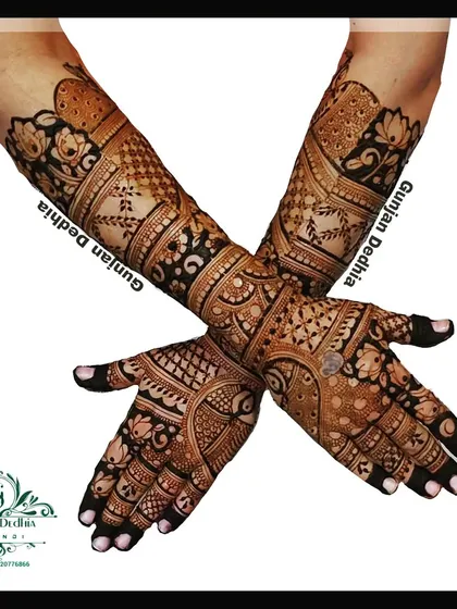 A full back-hand bridal mehendi design. The intricate patterns and motifs create a stunning 'glove' effect that is perfect for wedding photos.