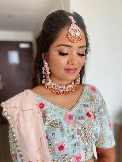 Pooja blossomed in this colorful look for her mehendi. I used pink and peach tones to match her floral jewelry and pastel blue lehenga.