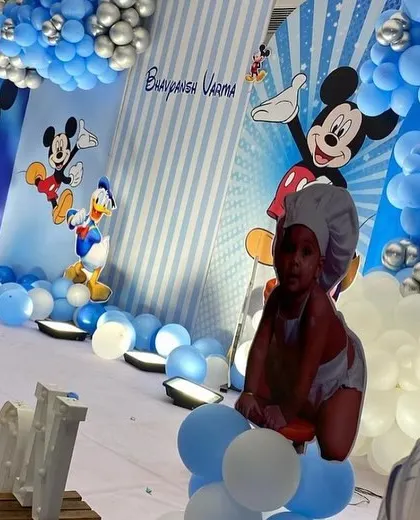 A close-up detail of the Mickey Mouse party decor, featuring personalized photos of the birthday boy.