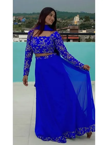 This vibrant royal blue crop-top lehenga with silver embroidery is a definite head-turner. It's a great rental option for a friend's wedding or a festive party.