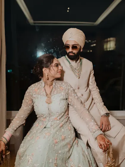 A stylish portrait of the Punjabi bride and groom. Their confident poses and coordinated outfits create a modern and regal look.