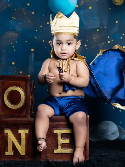 Our little space prince is ready to rule his galaxy, celebrating his first birthday among the stars and planets.
