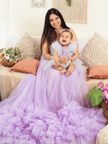 A mother and daughter share a laugh in matching gowns. We have outfits for moms too!