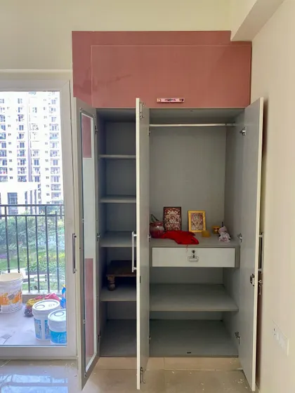 The interior of the kids' wardrobe, showing the practical arrangement of shelves and hanging space.