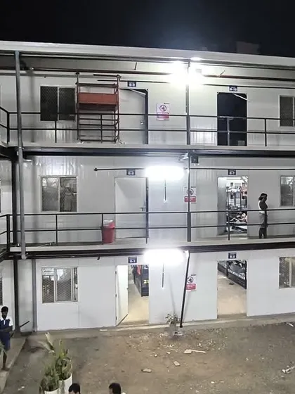 This closer view of the completed labor colony highlights the modular design, external staircases, and individual units. Our prefabricated solutions provide safe and comfortable accommodation.